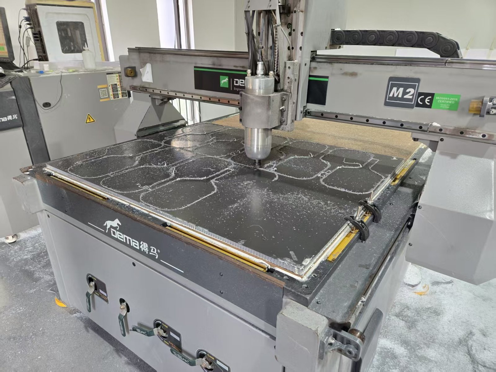 CNC cutting machine shaping composite pickleball paddle panels at Gloperti factory.