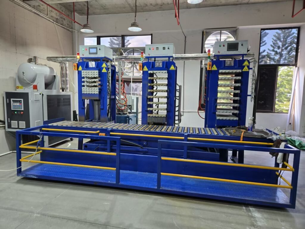 Thermoforming press equipment used in composite pickleball paddle manufacturing.