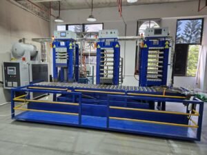 Thermoforming press equipment used in composite pickleball paddle manufacturing.